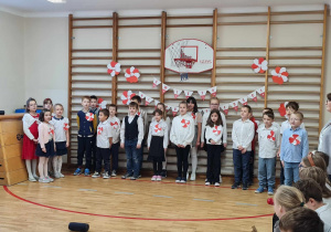 Uczniowie klas I-III śpiewają pieśni patriotyczne.